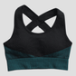 Textured black and teal sports bra with removable padding and criss-cross straps.