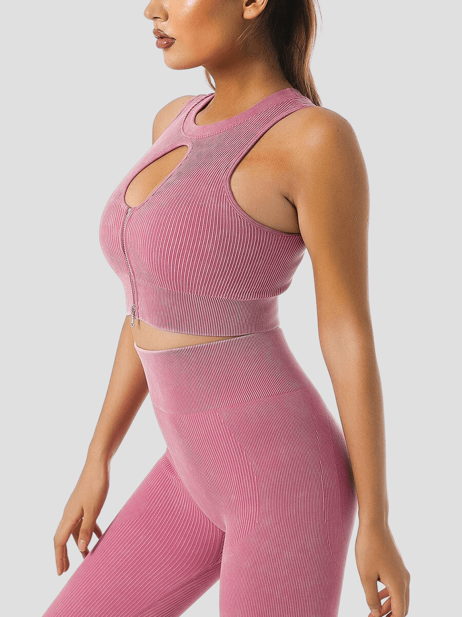 Woman wearing a ribbed pink halter sports bra and matching leggings by BodyFlexx.