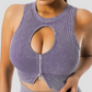 Woman wearing a ribbed purple sports bra with a peekaboo hole in the front showing off her cleavage. Activewear is designed by BodyFlexx.