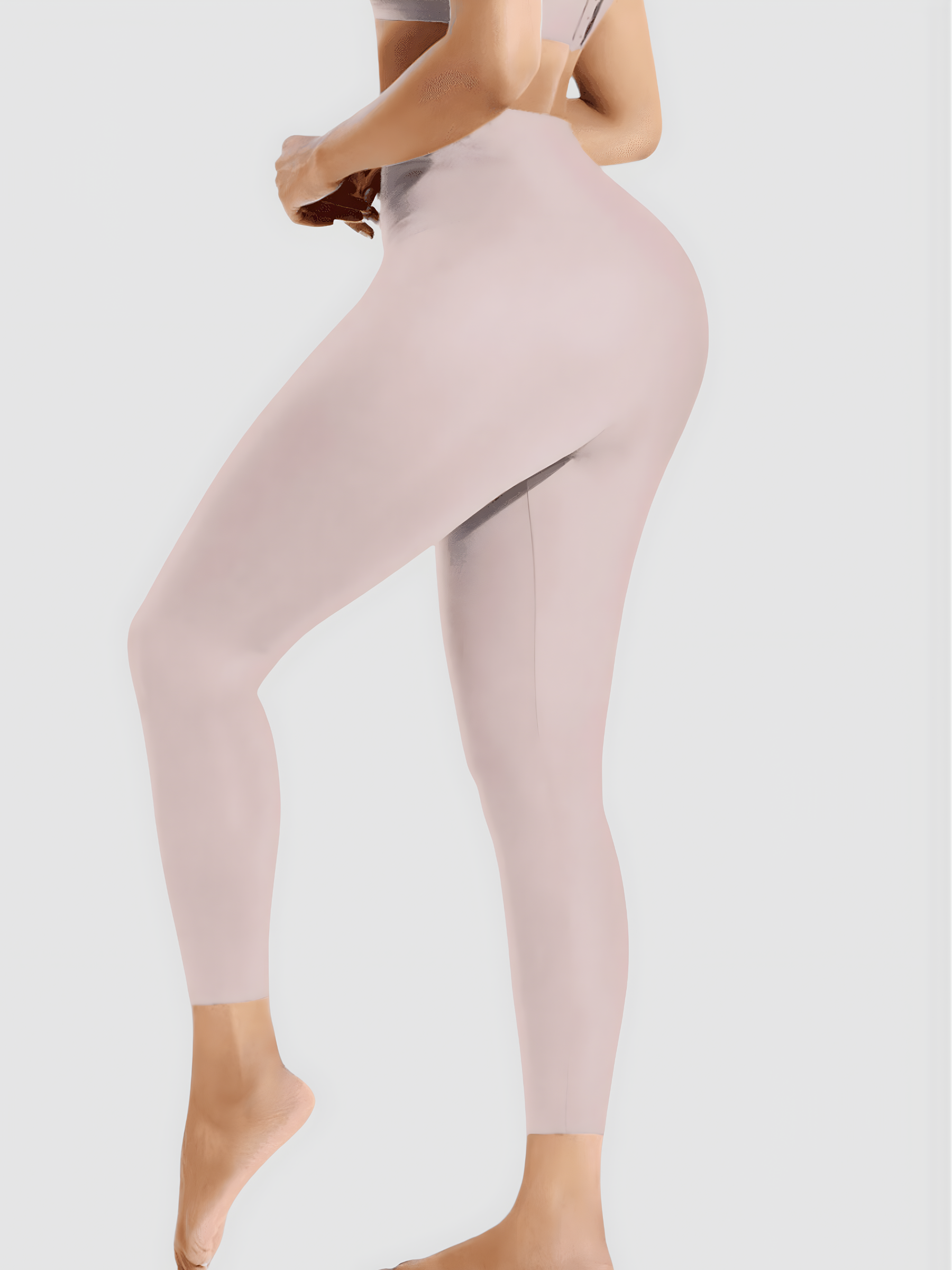 Woman posing in pink high waisted corset leggings for tummy-control and cellulite-smoothing by BodyFlexx Shapewear.