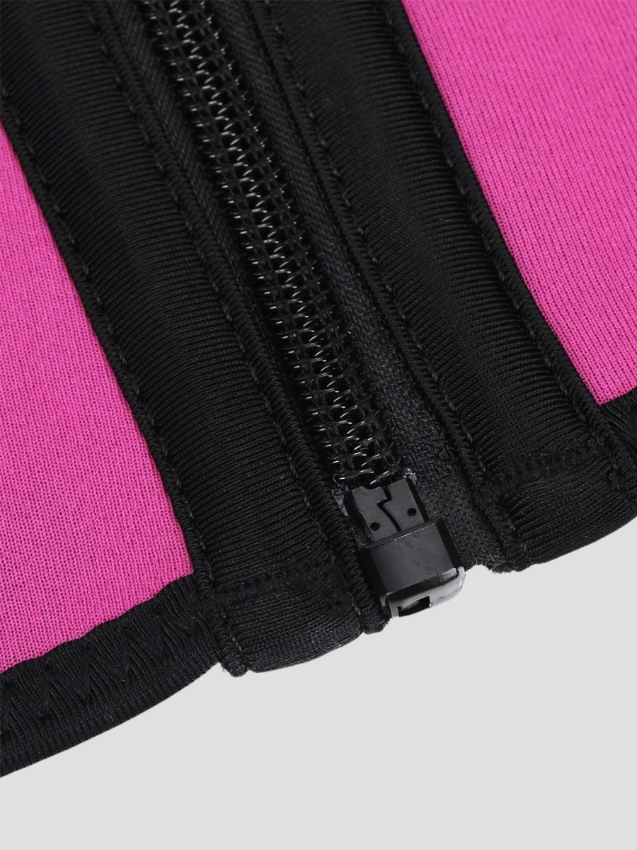 Close up view of the zipper on a sauna neoprene-lined activewear vest zipper. The vest is hot pink and black.
