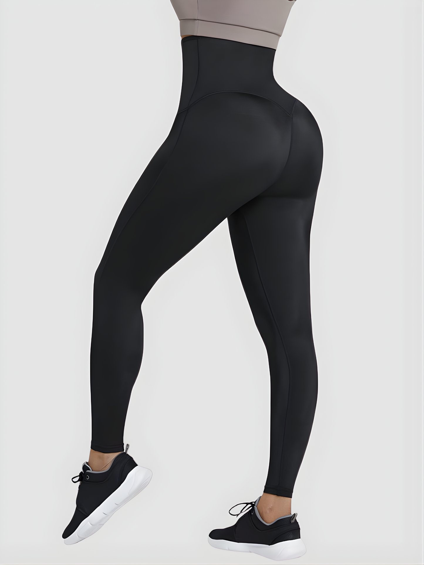 Woman posing wearing black waist-training sauna leggings by BodyFlexx.