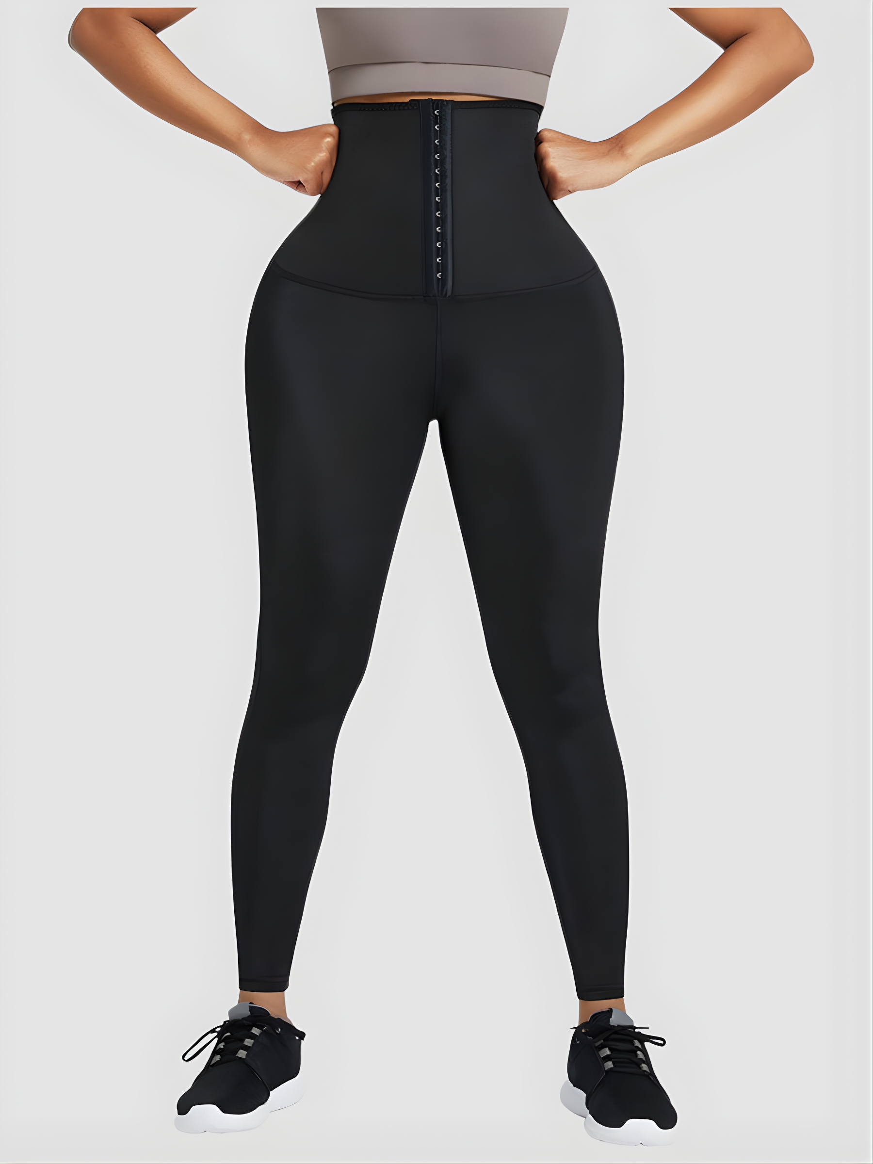 Woman wearing black waist-training sauna leggings by BodyFlexx.