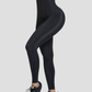 Woman wearing black high-waisted sauna leggings by BodyFlexx.