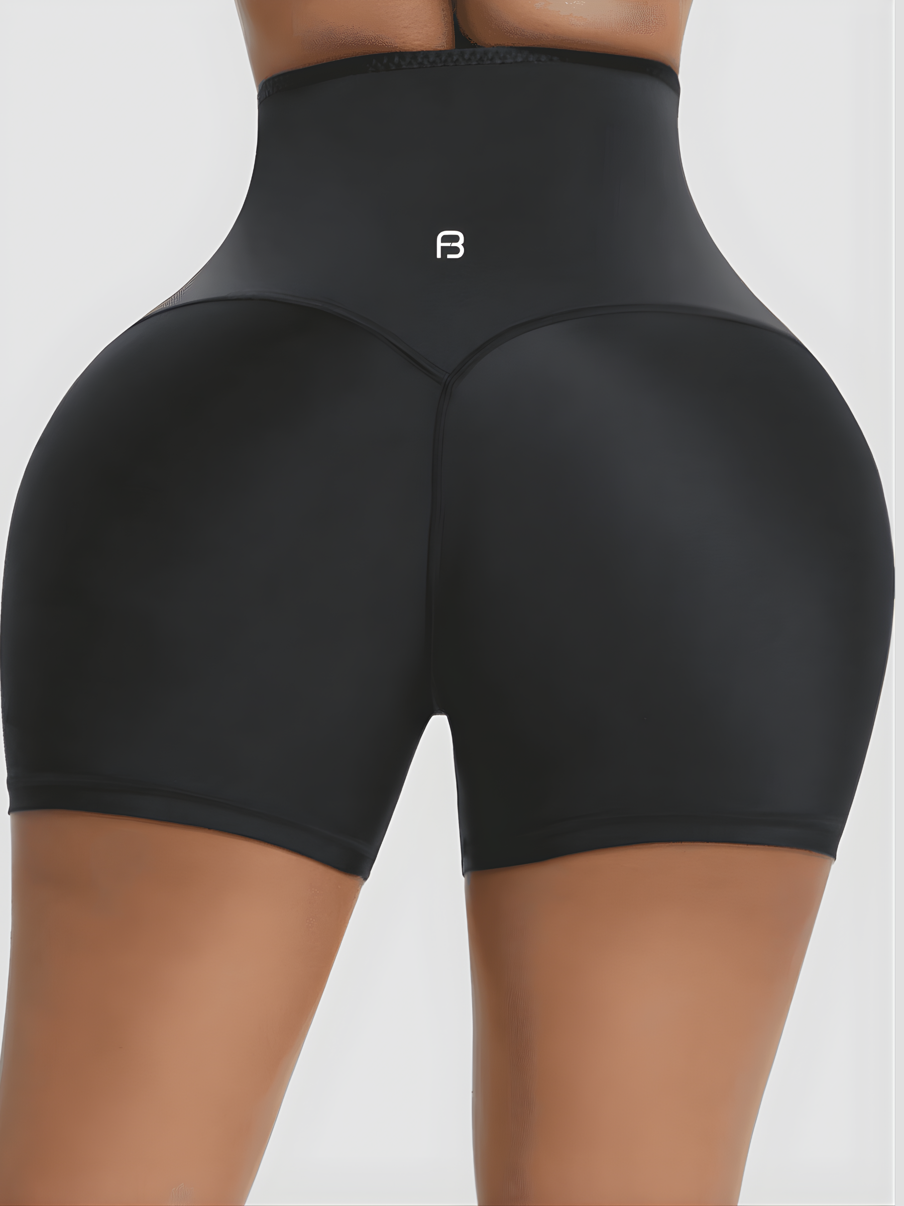 Woman wearing black Waist-Training Sauna Shorts with a corset closure by BodyFlexx.