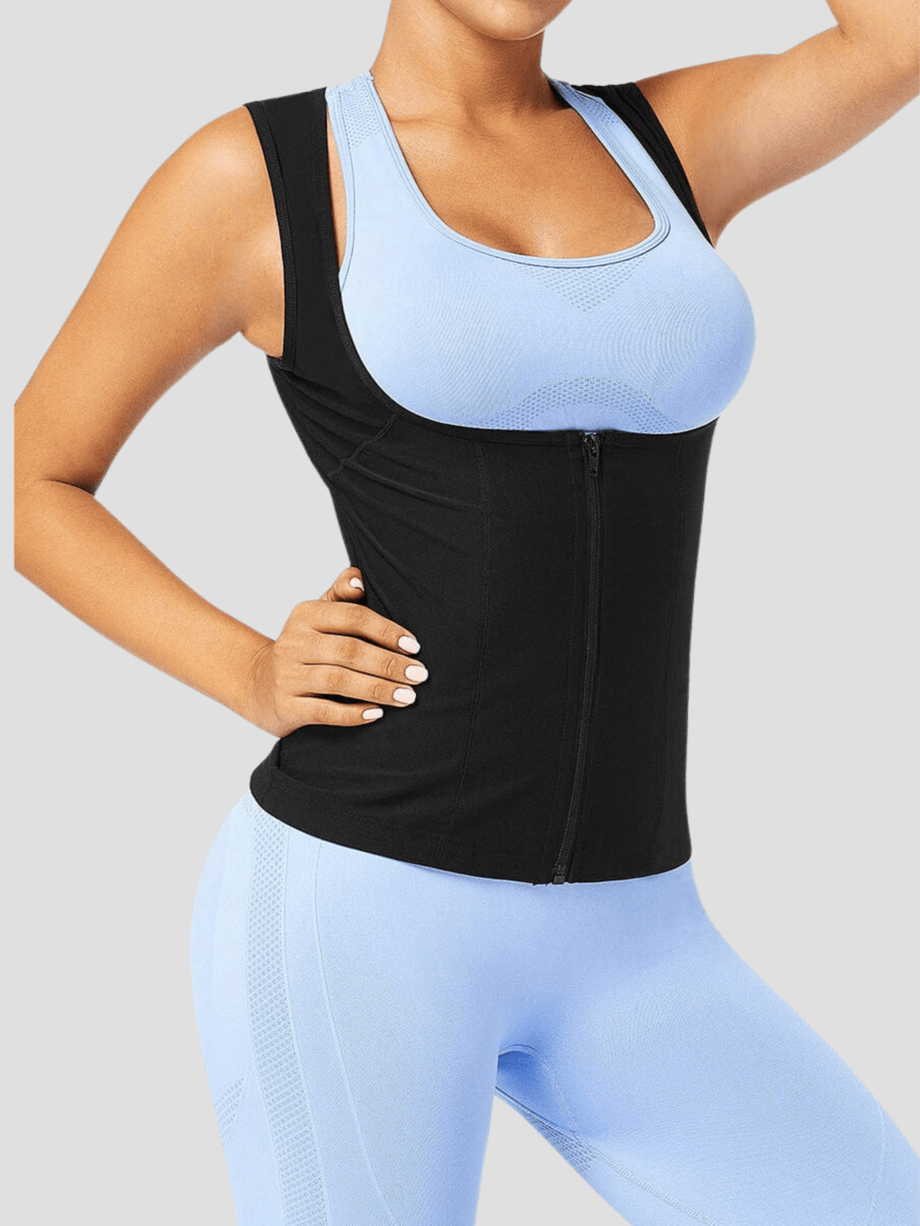 Person wearing a black sauna activewear vest by BodyFlexx over a light blue activewear outfit after a workout.