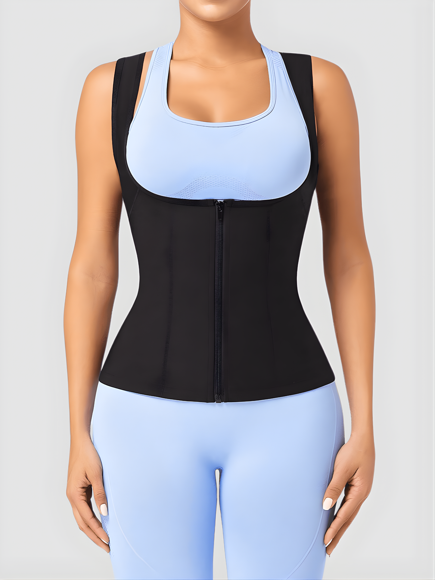 Person wearing a zippered neoprene-lined sauna vest to help with weight loss over a light blue activewear outfit.