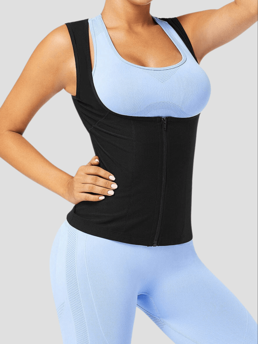 Woman wearing a black sauna activewear vest by BodyFlexx over a light blue activewear outfit after a workout.