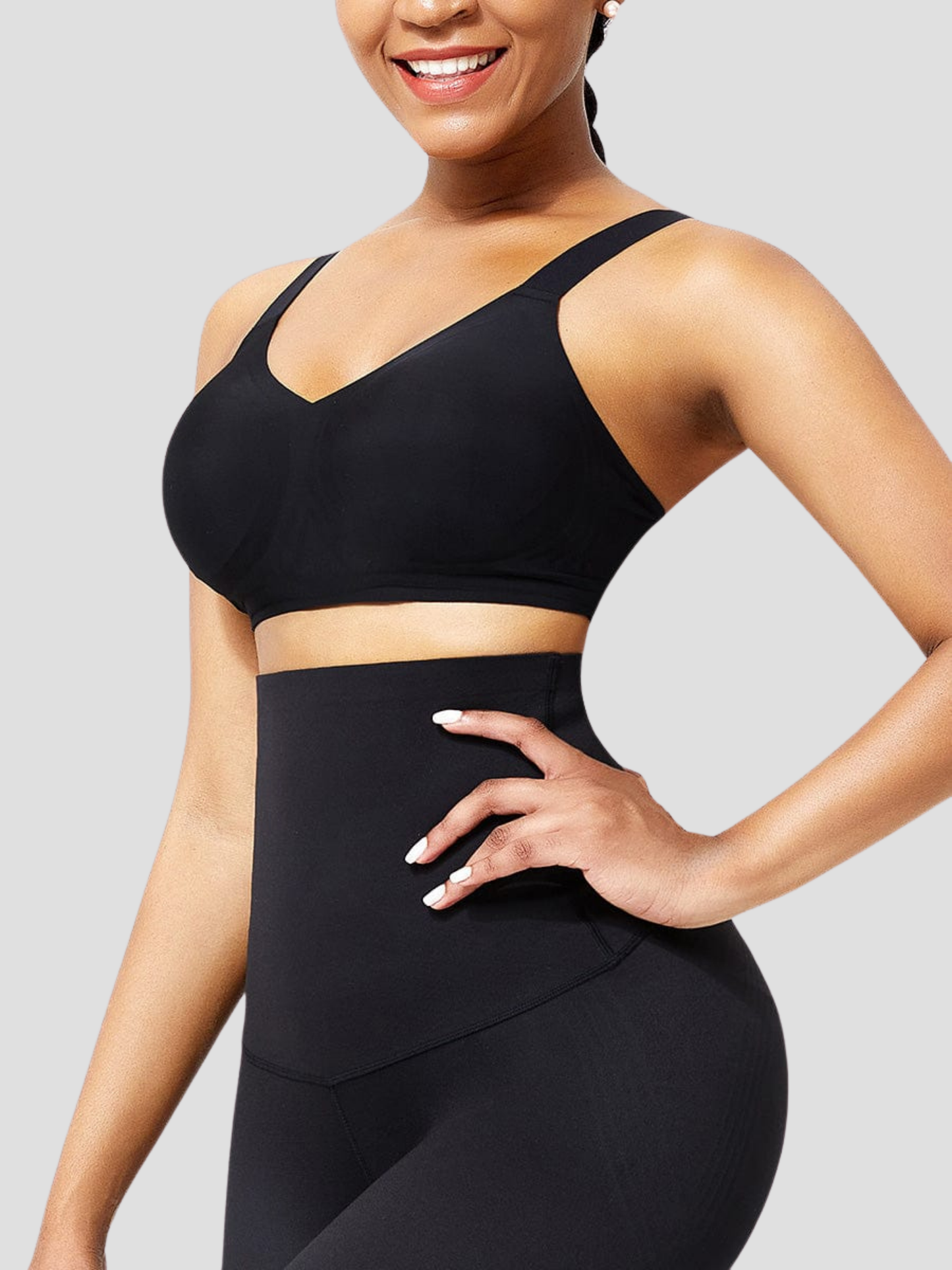 Woman wearing a black seamless and wireless padded t-shirt bra posing to show how supported and comfortable fer chest is.