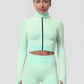 Cropped athletic set top with zipper stretchy jacket, workout outfit, athleisure, activewear, activewear sets, workout clothes for women, sweat-wicking, high compression, cellulite smoothing, BBL Jacket, plus size gym outfits, workout wear, gym wear, athletic outfits, nike, under armour, adidas, puma, champion, bombshell activewear, gymshark women, Girlfriend Collective, lululemon, Alo Yoga, Bandier, Athleta, Athletica, Fabletics, Revenge body, Teal Blue, Green.
