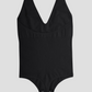 A black halter-style shapewear bodysuit with built-in removable bra padding and seamless thong design and a button crotch for convenience.
