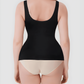 Woman wearing a black shaping tank top by BodyFlexx Shapewear and beige underwear.