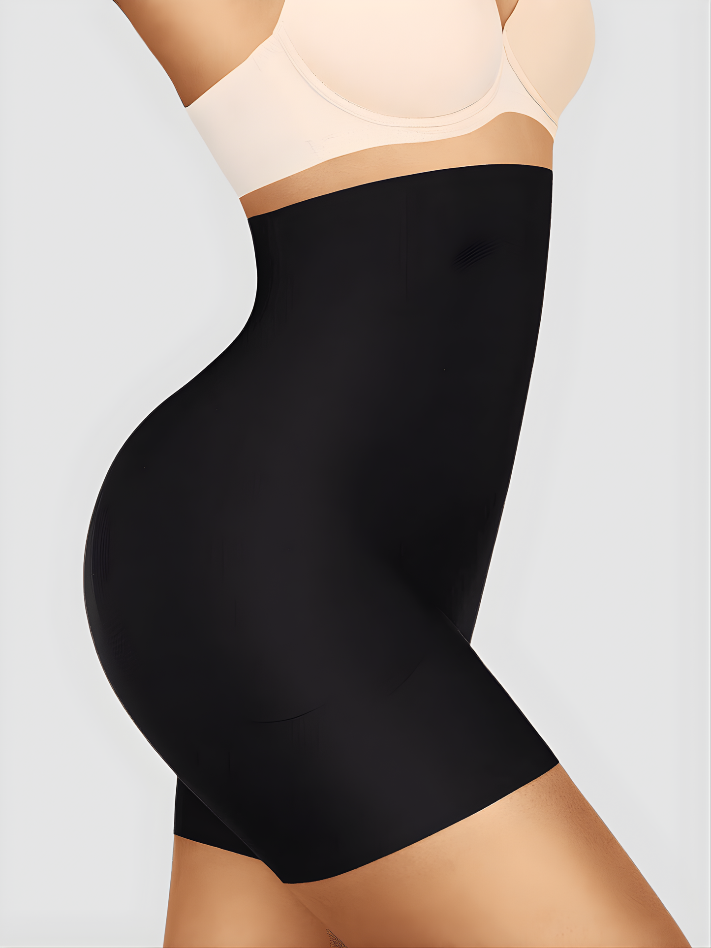 Woman wearing a black high-waisted shaping briefs with removable bum pads by BodyFlexx Shapewear.