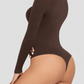Woman posing wearing a brown long-sleeve shaping bodysuit by BodyFlexx Shapewear.