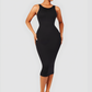 Woman wearing a black sleeveless midi shapewear dress by BodyFlexx.