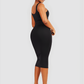 Woman wearing a black sleeveless sculpting dress with built-in shapewear by BodyFlexx.