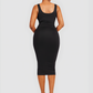 Woman wearing a black sleeveless shaping dress with built-in shapewear by BodyFlexx.