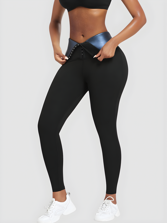 Woman wearing black BodyFlexx Waist-Training Sauna Leggings with the corset closure open showing a sweaty stomach after working out.