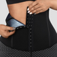 Close up of a woman undoing the waist training corset closure on a pair of black and gray sauna sweat belt lined activewear shorts.