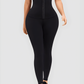Woman wearing black waist training leggings with an extra high corset-style closure to flatten her tummy and sculpt her curves.