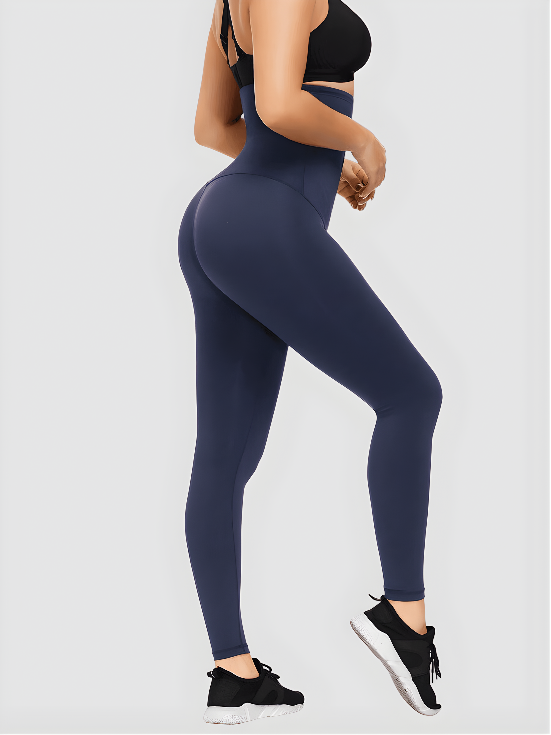 Woman posing in blue ultra-high waist-training corset leggings showing off her cellulite-free curves.