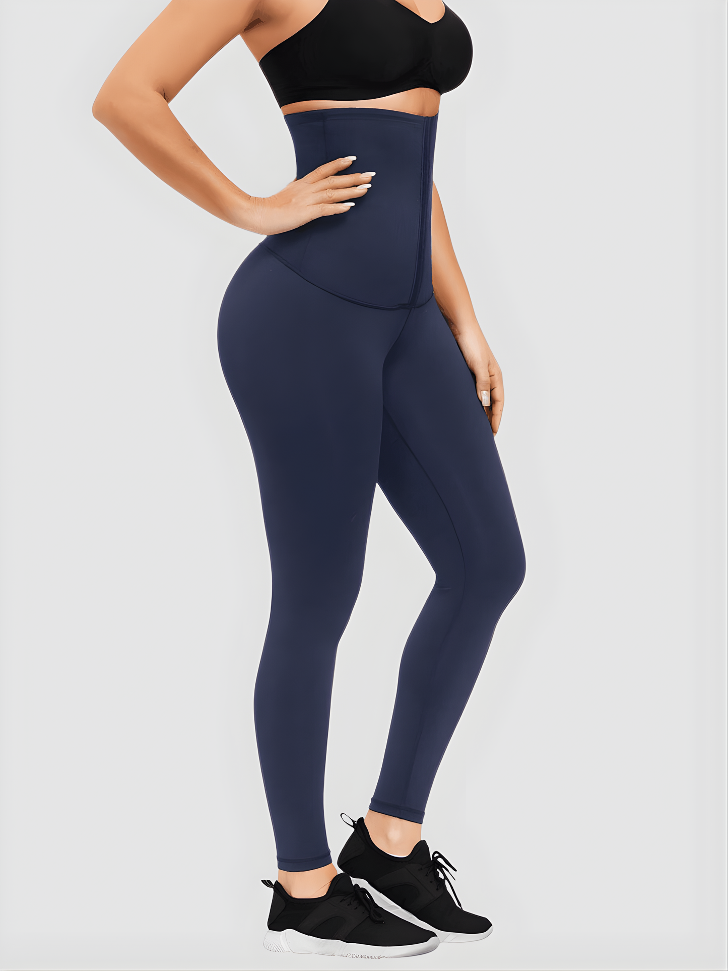 Woman posing in blue ultra-high waist-training corset leggings showing off her cellulite-free curves. Leggings by BodyFlexx Shapewear.