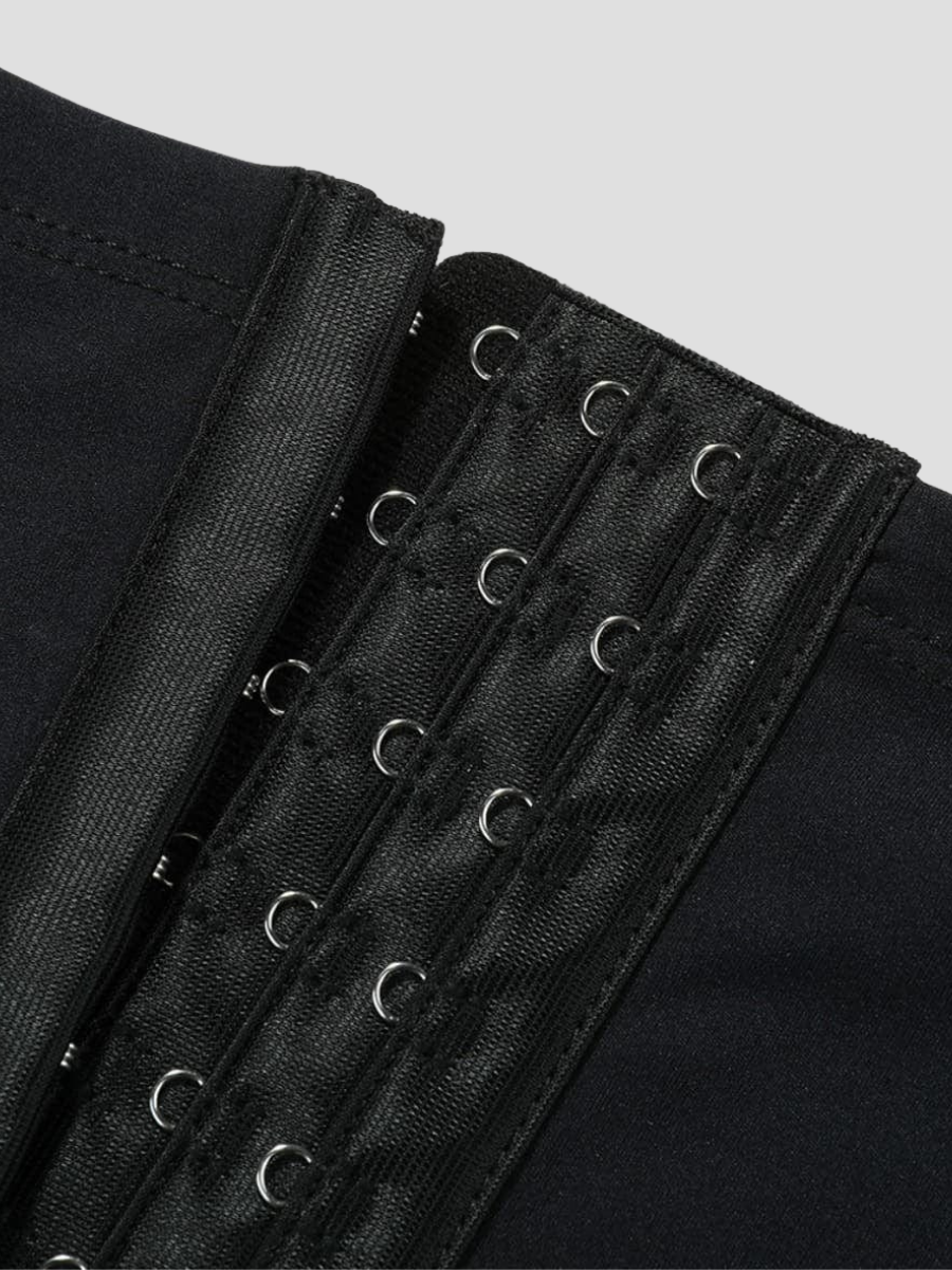 Close-up of a the corset-style hook and eye closure on a pair of black waist trainer leggings by BodyFlexx.