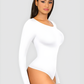 Woman wearing a white long-sleeve sculpting bodysuit by BodyFlexx Shapewear.