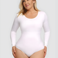 Woman wearing a long-sleeve white shapewear bodysuit by BodyFlexx.