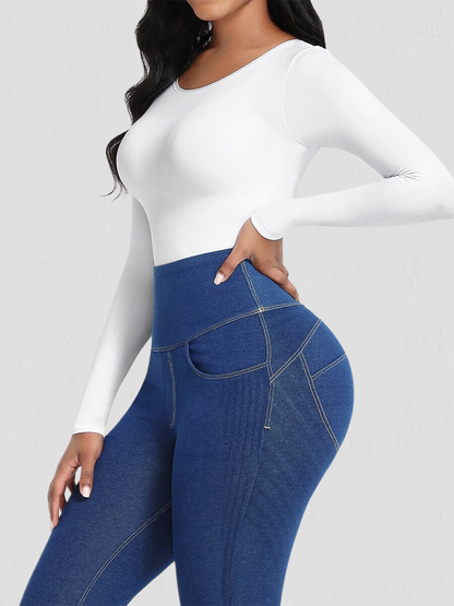 Woman wearing a white long-sleeve shaping bodysuit by BodyFlexx Shapewear with blue jeans.