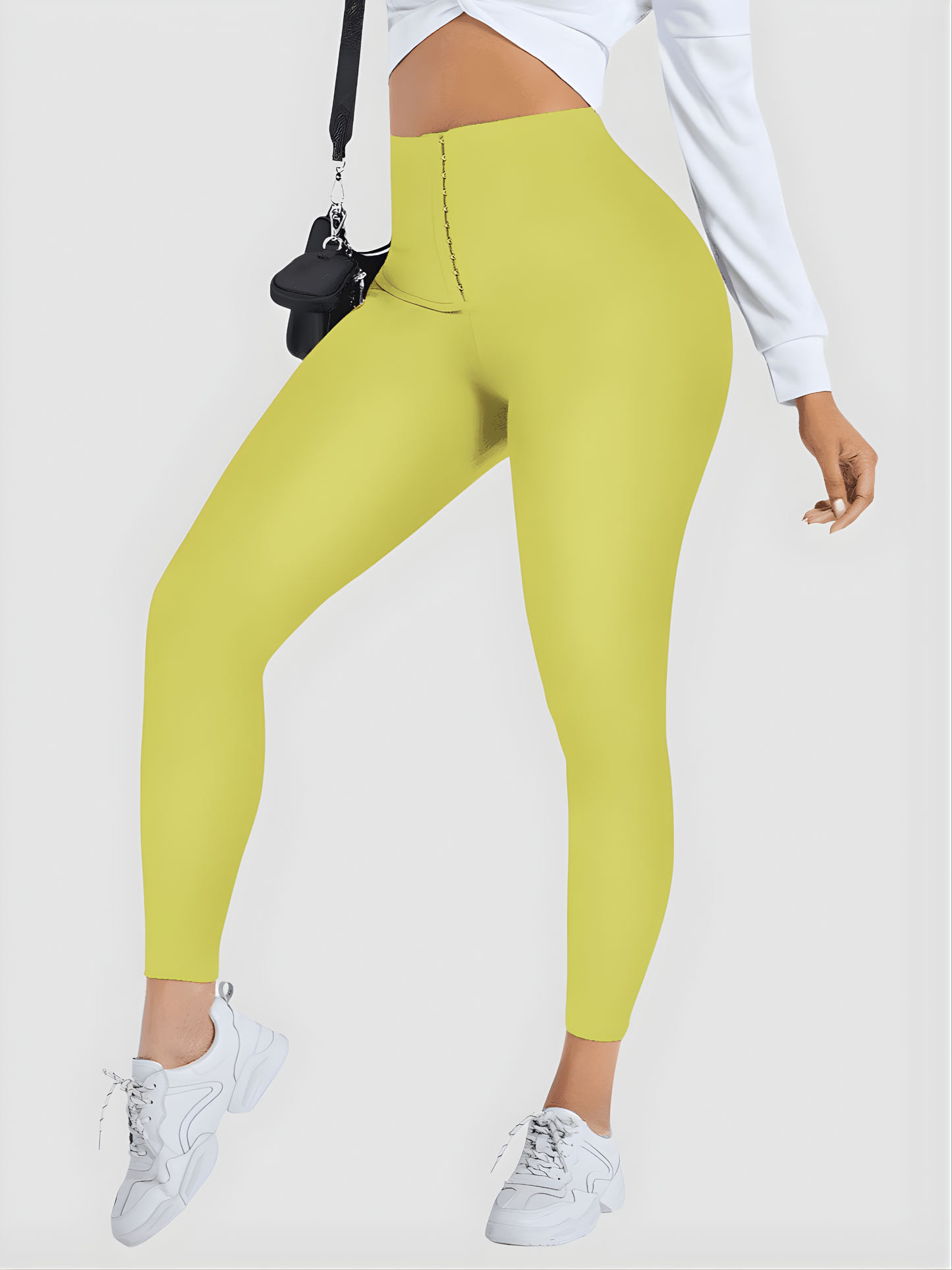 Woman wearing yellow waist training leggings by BodyFlexx Shapewear with a white blouse.