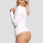 Laughing woman wearing a long-sleeved white bodysuit with built-in shapewear.