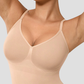 Woman wearing a nude colour mid-thigh tummy-control seamless shapewear bodysuit by BodyFlexx 