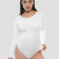 Woman wearing a white long-sleeve shapewear bodysuit against a plain background by BodyFlexx