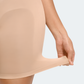 Woman wearing a nude color mid-thigh seamless shapewear bodysuit by BodyFlexx 