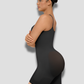 Woman wearing a black mid-thigh shapewear bodysuit with adjustable by BodyFlexx Shapewear.