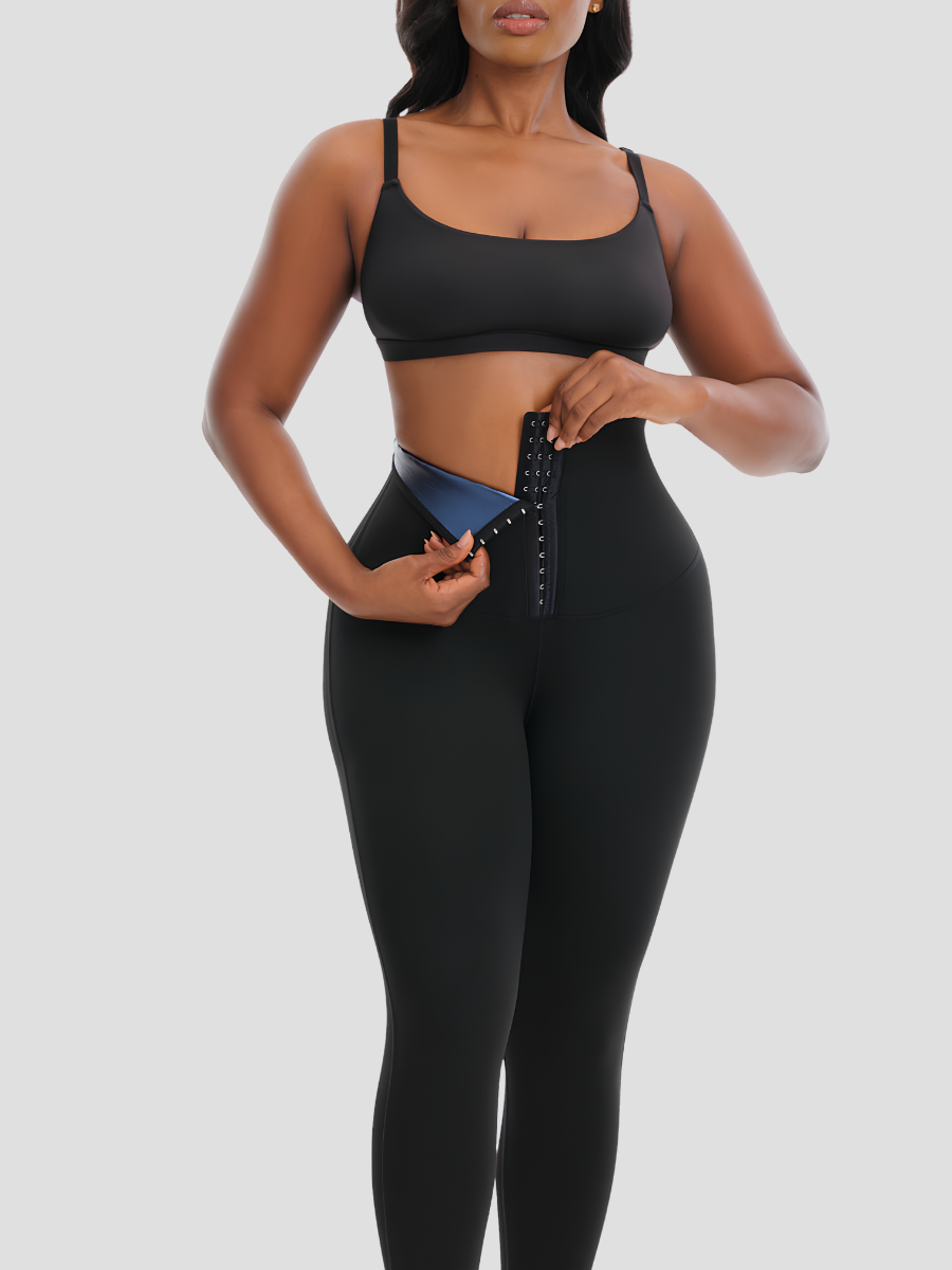Woman opening the corset closure on BodyFlexx Shapewear's black Sauna Sweat Belt Leggings.