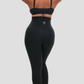 Woman wearing waist trainer leggings with a high corset-style closure in black.