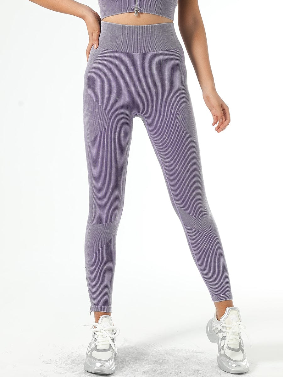 Woman wearing high-waisted ribbed purple leggings with a matching sports bra designed by BodyFlexx.