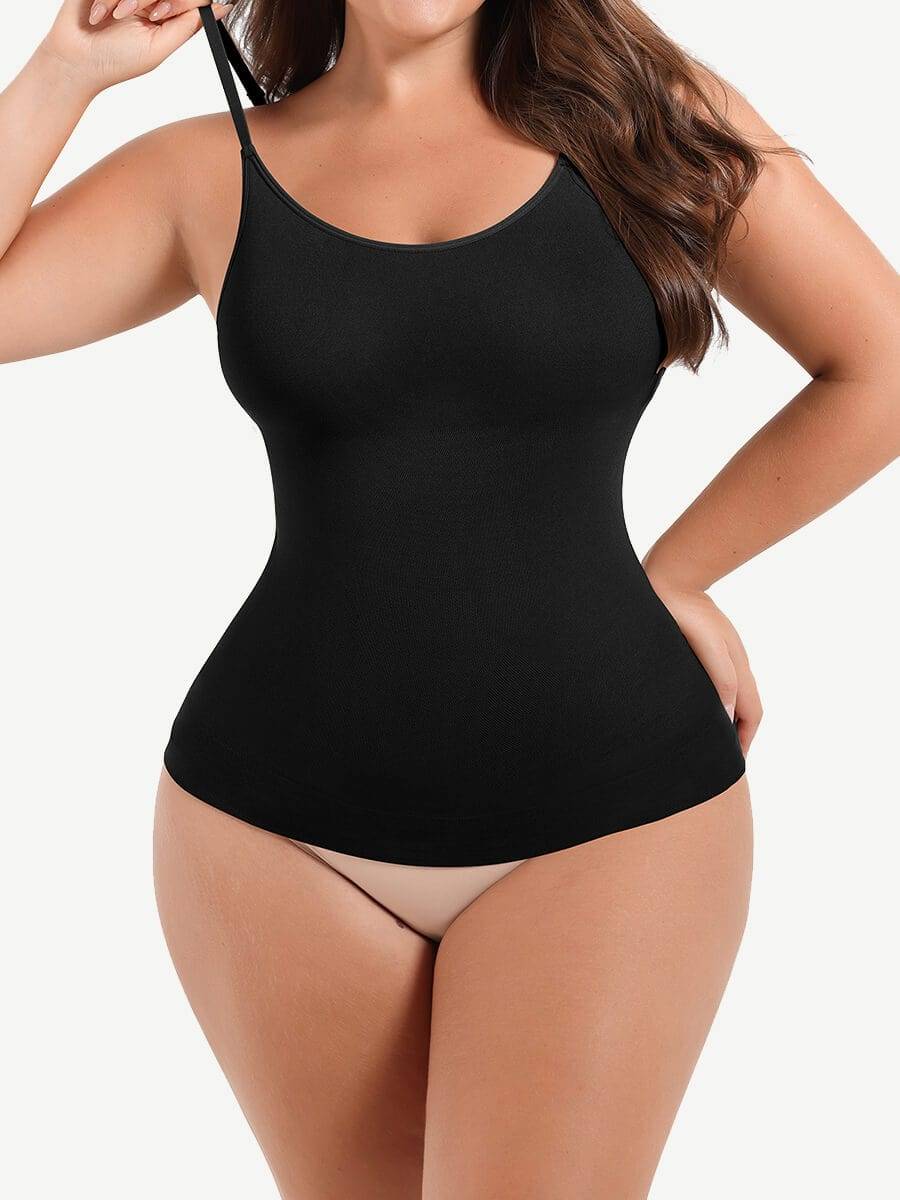 Woman wearing a black shapewear camisole with tummy control and adjustable straps.